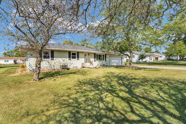 single story home featuring a garage and a front yard