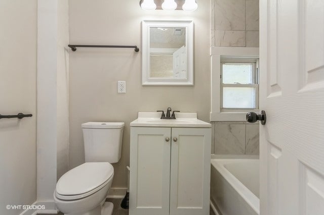 full bathroom with shower with separate bathtub, vanity, and toilet