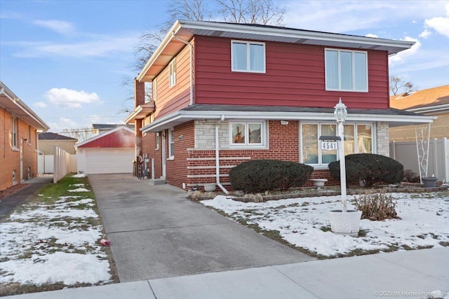 front of property featuring a garage and an outbuilding