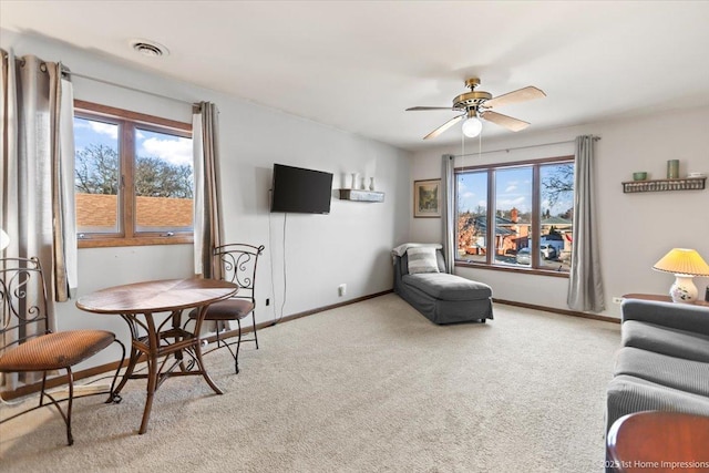 carpeted living room with ceiling fan