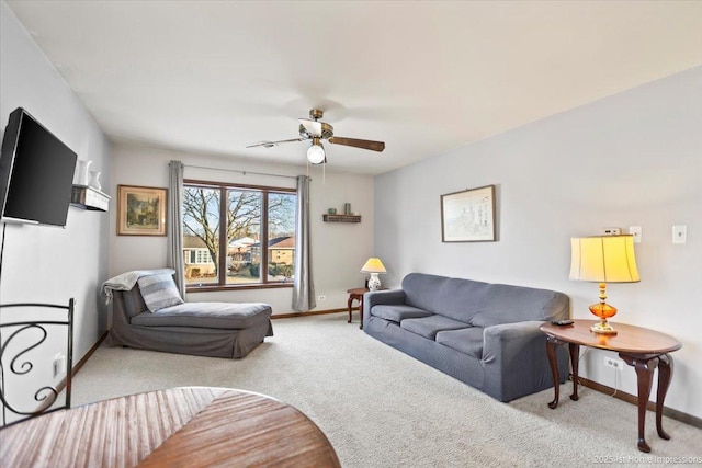 carpeted living room with ceiling fan