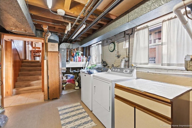 clothes washing area with independent washer and dryer