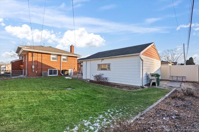 back of house featuring central air condition unit, a lawn, and a patio area