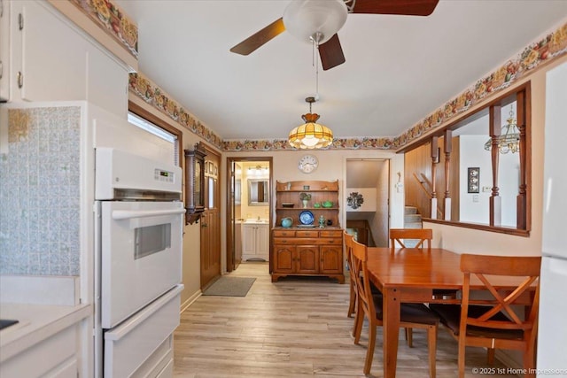 dining space featuring ceiling fan and light hardwood / wood-style flooring