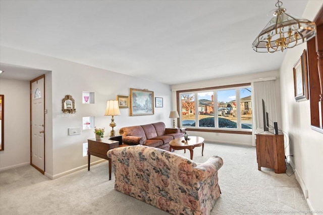 carpeted living room featuring a chandelier