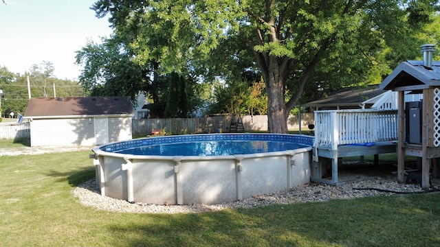 view of pool with a yard and a storage unit