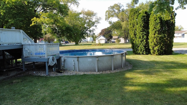 view of pool featuring a wooden deck and a yard