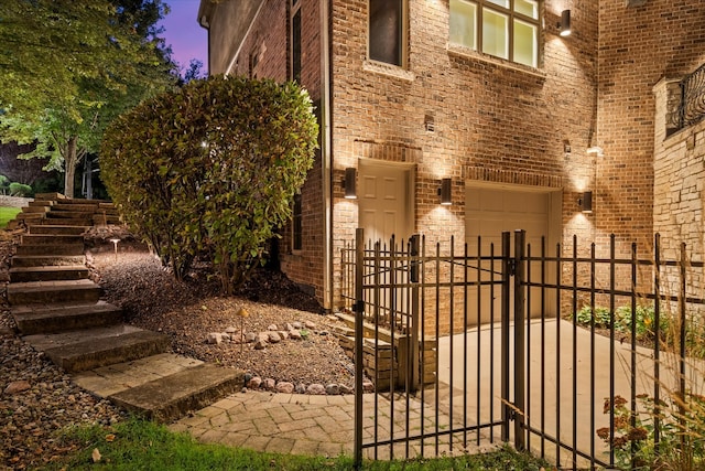 property exterior at dusk featuring a garage