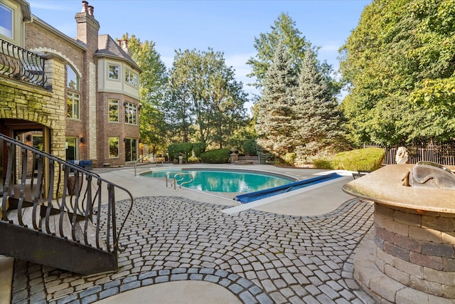 view of swimming pool featuring a patio