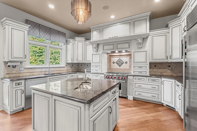 kitchen with light hardwood / wood-style flooring, a center island, sink, and stainless steel appliances