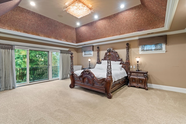 carpeted bedroom with access to exterior, a notable chandelier, crown molding, and a tray ceiling