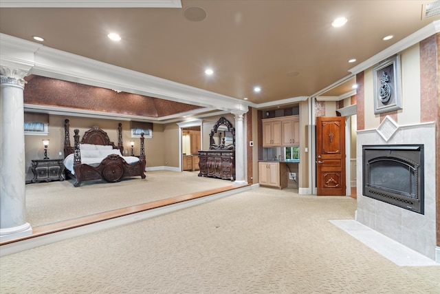 unfurnished bedroom featuring a tile fireplace, light carpet, crown molding, and decorative columns