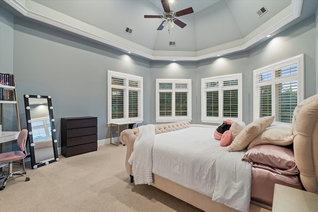 carpeted bedroom featuring high vaulted ceiling, ceiling fan, and a tray ceiling