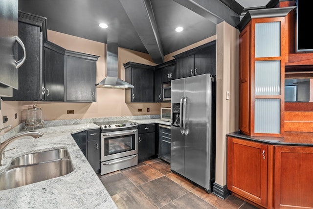 kitchen with sink, wall chimney range hood, beam ceiling, light stone countertops, and appliances with stainless steel finishes