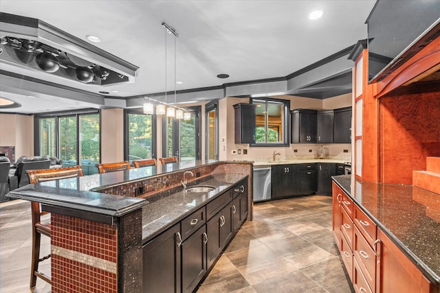 kitchen with decorative light fixtures, a large island, a breakfast bar area, dishwasher, and dark stone countertops