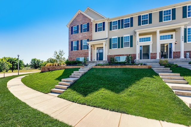 view of front of property with a garage and a front lawn