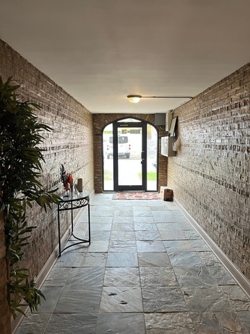 hallway with brick wall