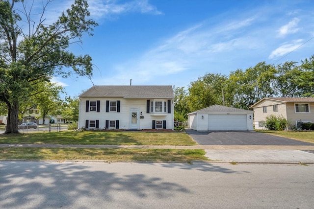 view of front of home featuring a front yard, an outdoor structure, and a garage