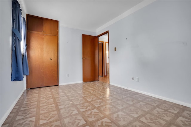 unfurnished bedroom with a closet and light parquet floors