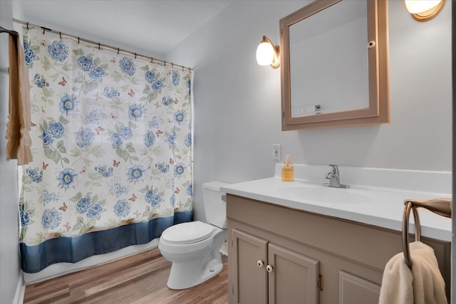 bathroom featuring wood-type flooring, vanity, and toilet