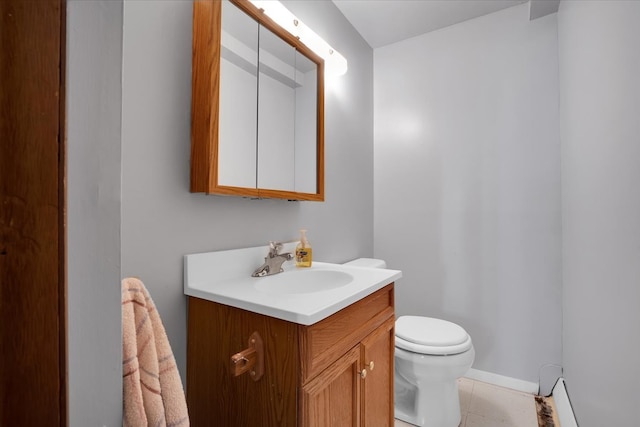 bathroom with tile patterned flooring, vanity, and toilet