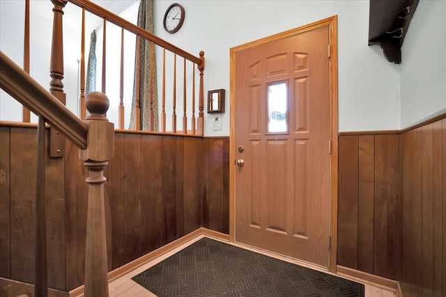 entryway featuring wood walls and hardwood / wood-style flooring