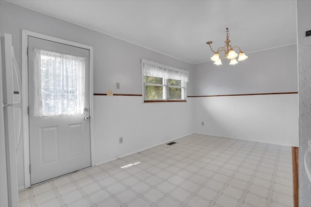 entrance foyer featuring crown molding and a notable chandelier