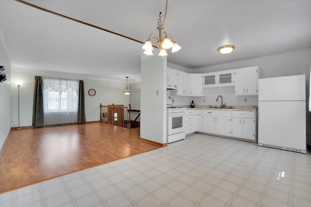 kitchen featuring an inviting chandelier, white appliances, white cabinetry, and hanging light fixtures