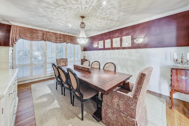 611 Elmwood Ave, Wilmette, IL 60091 - dining space featuring wood finished floors, a chandelier, wainscoting, and ornamental molding
