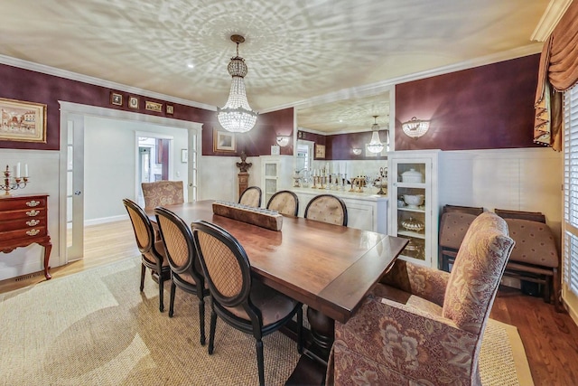 611 Elmwood Ave, Wilmette, IL 60091 - dining area with a chandelier, wood finished floors, ornamental molding, and wainscoting