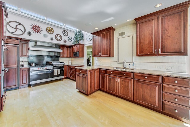 611 Elmwood Ave, Wilmette, IL 60091 - kitchen with stainless steel appliances, wall chimney exhaust hood, decorative backsplash, light stone counters, and recessed lighting