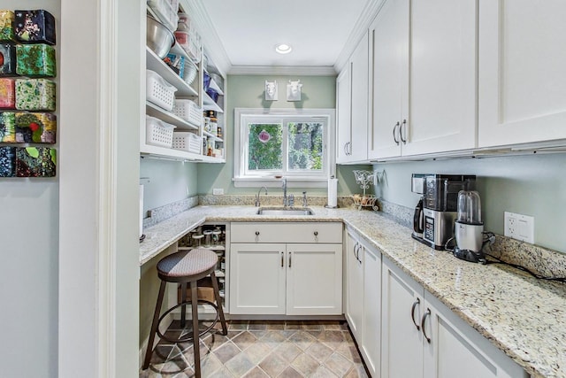611 Elmwood Ave, Wilmette, IL 60091 - kitchen with white cabinetry, crown molding, light stone countertops, recessed lighting, and open shelves