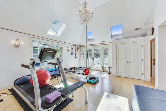 611 Elmwood Ave, Wilmette, IL 60091 - workout room with a skylight, wood finished floors, high vaulted ceiling, french doors, and a chandelier