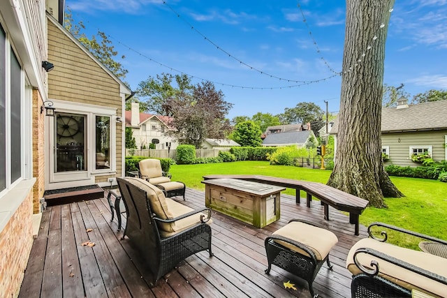 wooden deck with a yard and fence