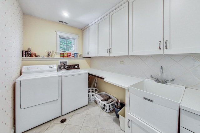 611 Elmwood Ave, Wilmette, IL 60091 - laundry room with cabinet space, washer and dryer, and light tile patterned floors