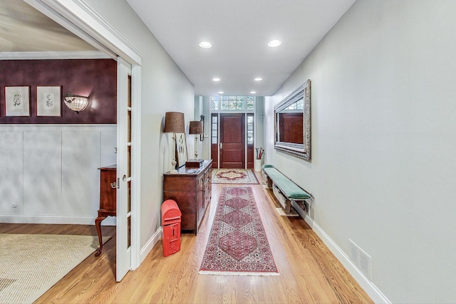hall with recessed lighting, baseboards, visible vents, and light wood finished floors