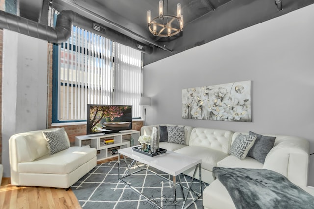 living room with dark hardwood / wood-style floors and a chandelier