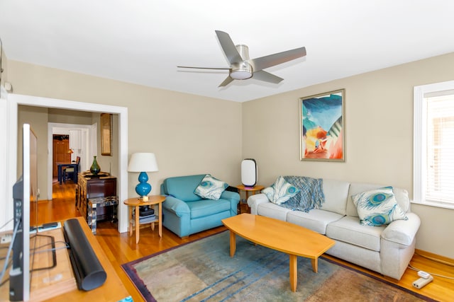 living room featuring hardwood / wood-style floors and ceiling fan