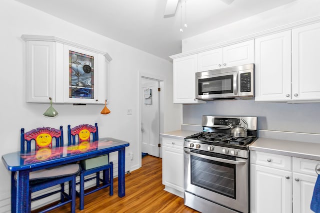 kitchen with white cabinetry, ceiling fan, appliances with stainless steel finishes, and light hardwood / wood-style flooring