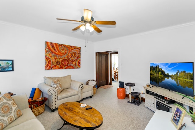 carpeted living room with ornamental molding and ceiling fan