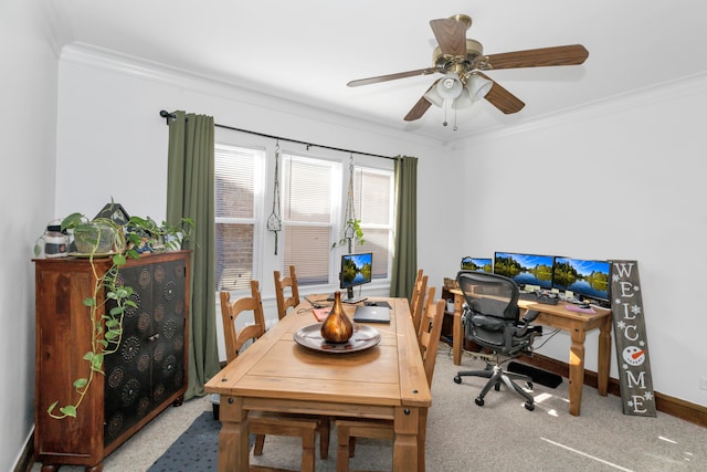 carpeted dining space with ornamental molding and ceiling fan