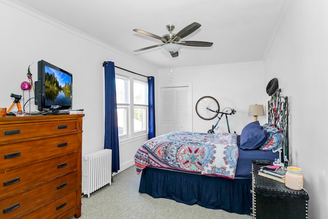 bedroom with radiator heating unit, ceiling fan, ornamental molding, a closet, and light colored carpet