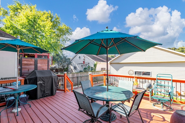 wooden deck with a grill