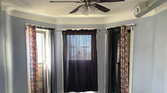 interior details with ceiling fan and crown molding