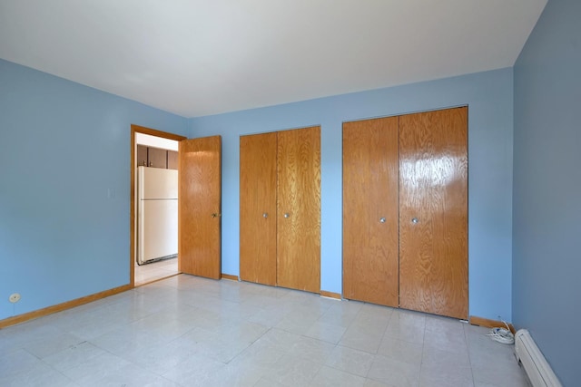 8545 Arnold St Unit 3Se, River Grove, IL 60171 - unfurnished bedroom with freestanding refrigerator, baseboard heating, multiple closets, and baseboards