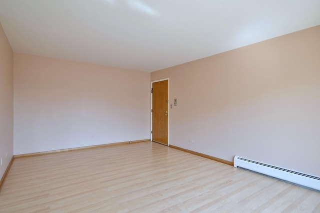 8545 Arnold St Unit 3Se, River Grove, IL 60171 - spare room featuring baseboard heating, light wood finished floors, and baseboards