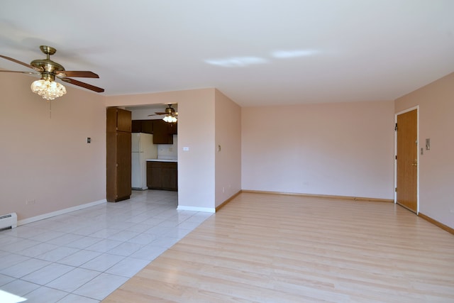 spare room with ceiling fan and light hardwood / wood-style flooring