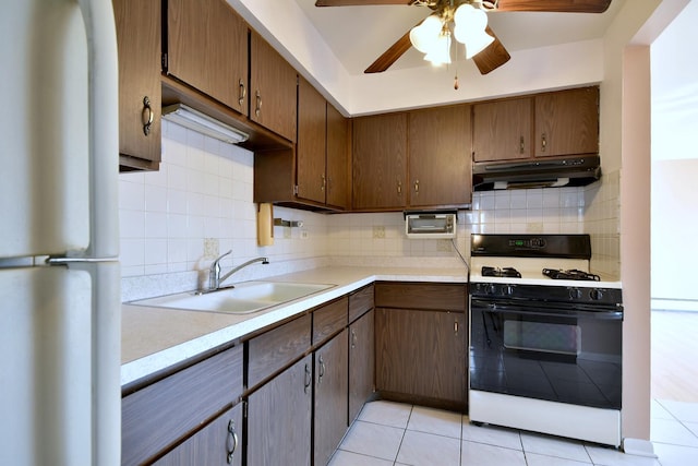 8545 Arnold St Unit 3Se, River Grove, IL 60171 - kitchen with white appliances, a sink, under cabinet range hood, light tile patterned flooring, and ceiling fan