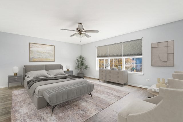 bedroom with light hardwood / wood-style floors and ceiling fan