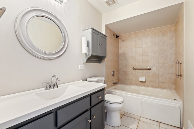 full bathroom with toilet, tiled shower / bath, vanity, and tile patterned floors